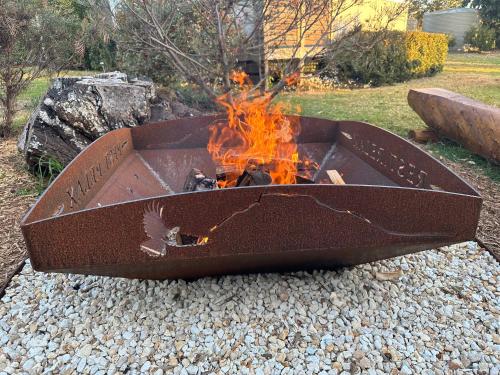 a fire pit sitting on a pile of rocks at Orange Blossom- Comboyne Mountain Cottages in Comboyne