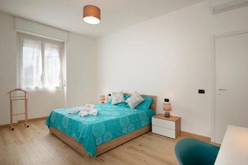 a bedroom with a blue bed with a blue blanket at MONZA MILANO 10 Min Centro Stazione Fs CASA ORIETTA in Monza