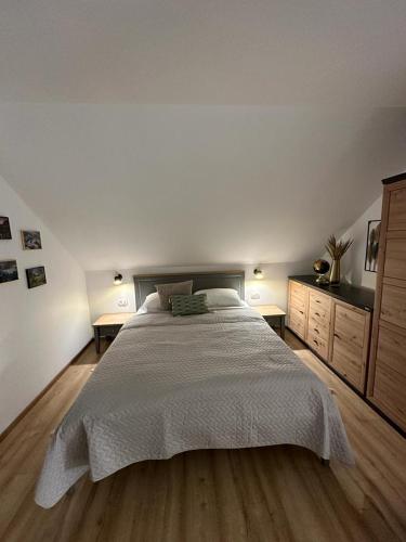 a bedroom with a large bed and two night stands at Apartments Green Linden in Lipovača