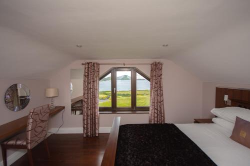a bedroom with a bed and a window and a desk at Fuchsia Lodge - New Luxury 5* Beachside Lodge with Sauna - 4 beds ensuite - Spectacular Location in Cahersiveen