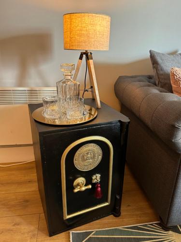 a end table with a clock on it next to a couch at Spacious Luxury Waterfront Apartment in Ipswich