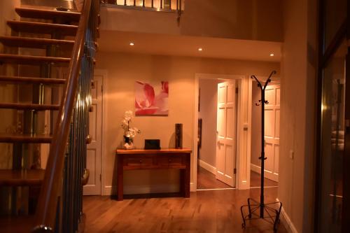a hallway with a desk in a house at Fuchsia Lodge - New Luxury 5* Beachside Lodge with Sauna - 4 beds ensuite - Spectacular Location in Waterville