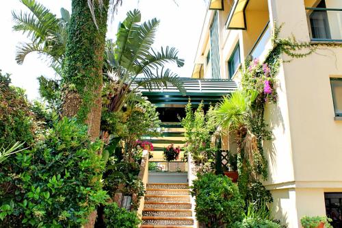 a staircase leading up to a building with plants at Hotel Relais I Presidi in Orbetello