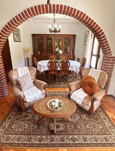a living room with a table and chairs at VILA GUIA in Valdreu in Braga