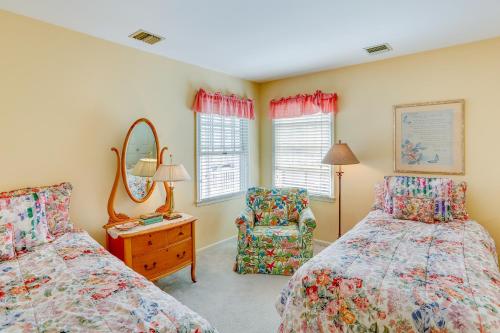 a bedroom with two beds and a chair and a mirror at Ocean City Home 1 Block to Beach and Boardwalk! in Ocean City