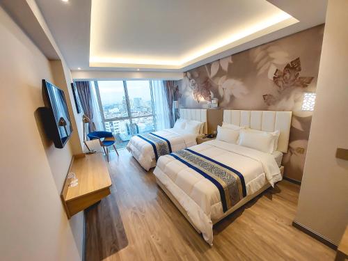 Ένα ή περισσότερα κρεβάτια σε δωμάτιο στο Gold Source Hotel