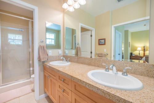 a bathroom with two sinks and a shower at Princeville Condo with AC, Pool, Garage, Beach Gear 27B in Princeville