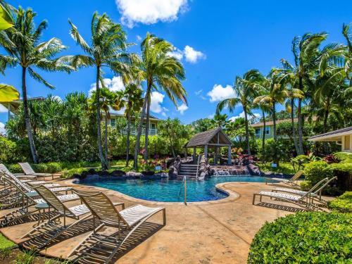 a resort pool with lounge chairs and a gazebo at Princeville Condo with AC, Pool, Garage, Beach Gear 27B in Princeville