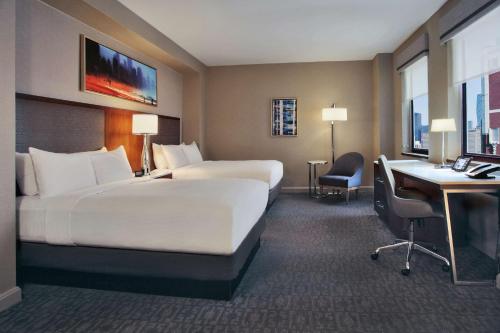 a hotel room with two beds and a desk and a computer at Hilton Chicago in Chicago