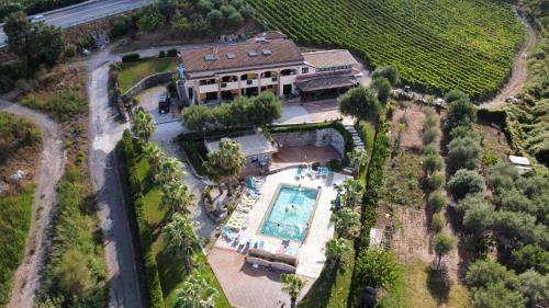 an aerial view of a house with a swimming pool at Tenuta del Bifan in Policastro Bussentino