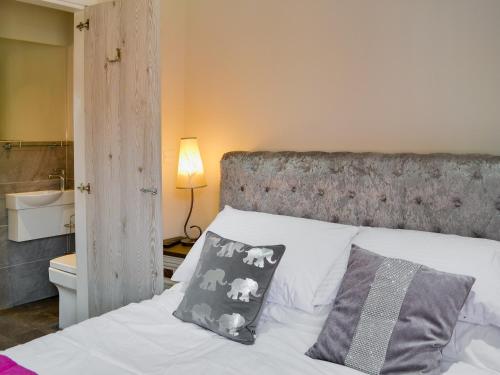 a bedroom with a bed with two pillows on it at Regent Cottage in Beverley