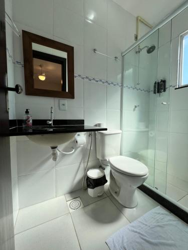 a bathroom with a toilet and a sink and a shower at La Coquille in Praia de Araçatiba