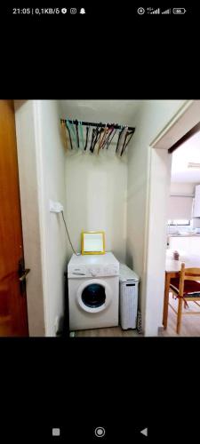 a laundry room with a washing machine and a table at Vicky apartment in Paralimni