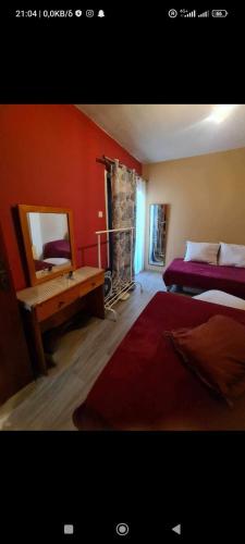 a bedroom with two beds and a mirror and a fireplace at Vicky apartment in Paralimni
