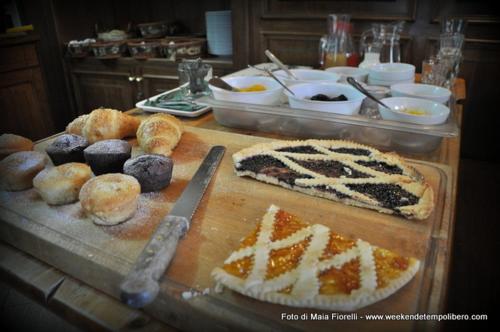 a table with various pastries and donuts on at Hotel Le Soleil in Challand Saint Anselme