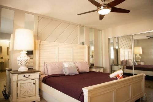 a bedroom with a bed and a ceiling fan at Rancho Mirage Palm Springs Resort-Golf Tennis Pool in Rancho Mirage