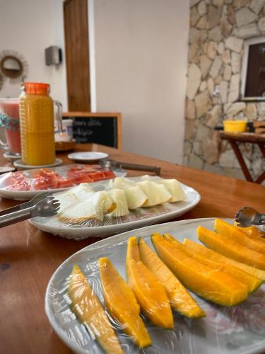 two plates of food on a wooden table at Oka Pousada Atins in Atins