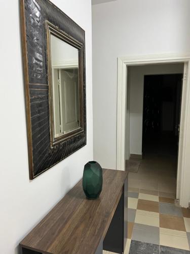a mirror and a vase on a table in a room at Residence B&B Hibiscus in Dakar