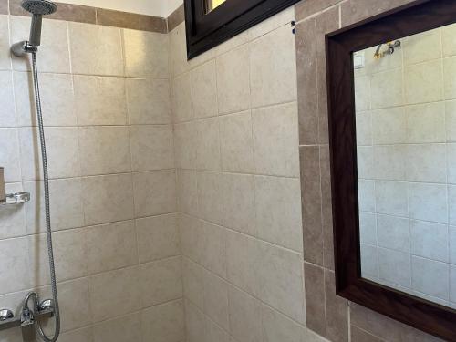 a bathroom with a shower with a glass door at Residence B&B Hibiscus in Dakar