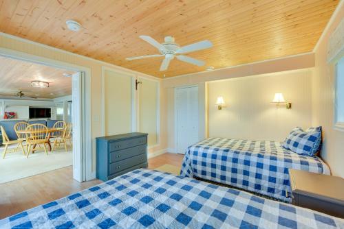 a bedroom with two beds and a ceiling fan at Spacious Lakefront New Auburn Home with Sunroom in Chetek