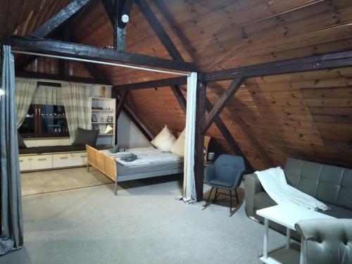 a attic room with a bed and a chair at 100 Stufen über dem Rhein in Oberwesel