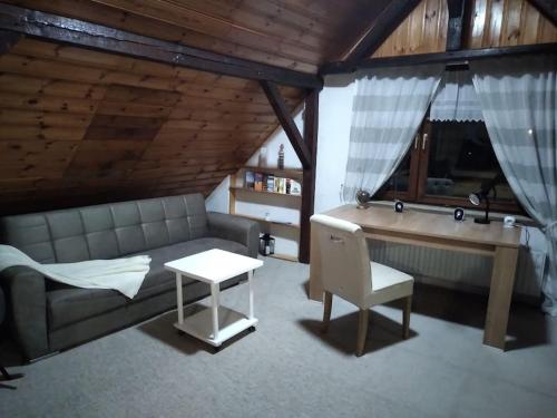 a living room with a couch and a desk at 100 Stufen über dem Rhein in Oberwesel