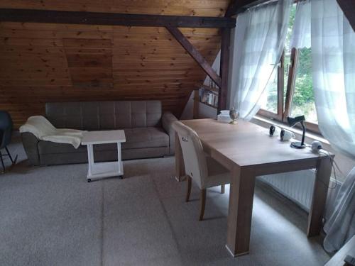 a living room with a table and a couch at 100 Stufen über dem Rhein in Oberwesel