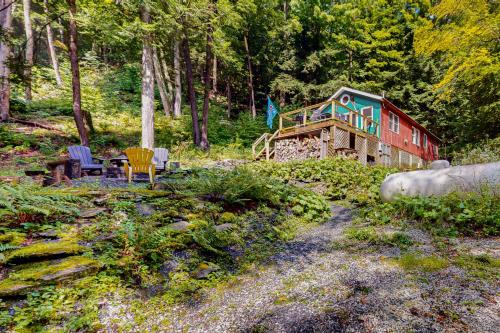 a house in the woods with a table and chairs at Beebe Pond Paradise in Castleton