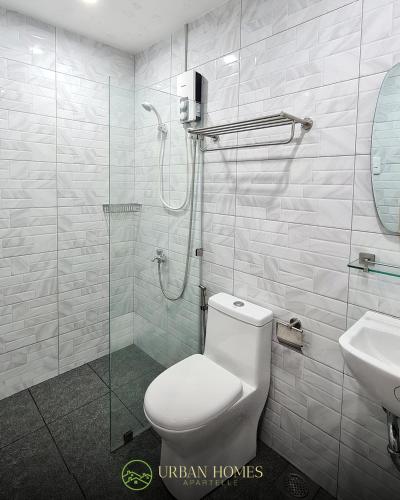 a bathroom with a shower and a toilet and a sink at Urban Homes Bohol in Tagbilaran City