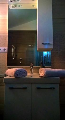 a bathroom counter with a sink and a mirror at Villa Palas Apartments 2 in Rogoznica