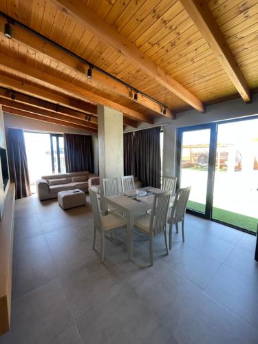 a dining room with a table and chairs and a couch at Luxury Rooftop Vlora in Vlorë