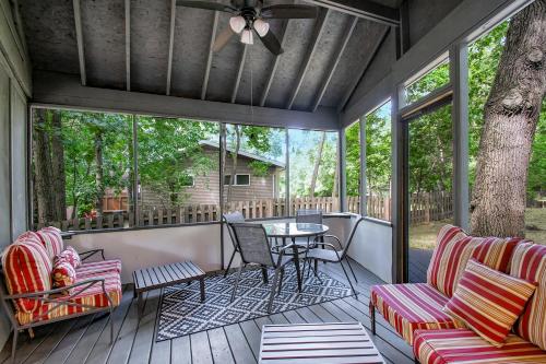 a screened in porch with a table and chairs at The Tulip Tree House in New Buffalo