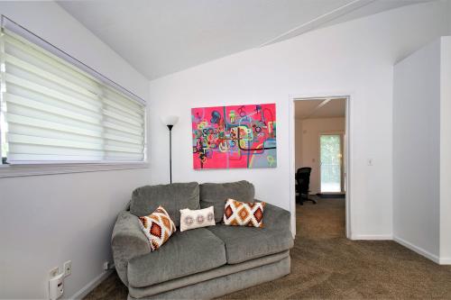 a living room with a couch and a painting on the wall at The Tulip Tree House in New Buffalo