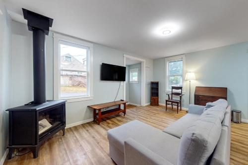 a living room with a couch and a fireplace at The Quacker Jack in Port Orchard