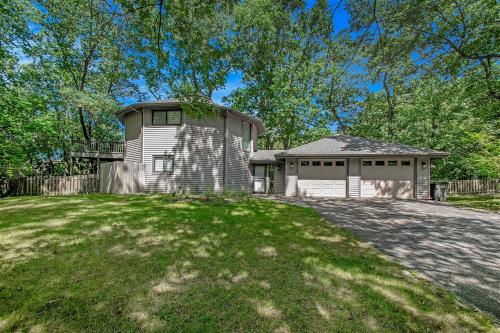 a large house with a garage on a lawn at The Tulip Tree House in New Buffalo