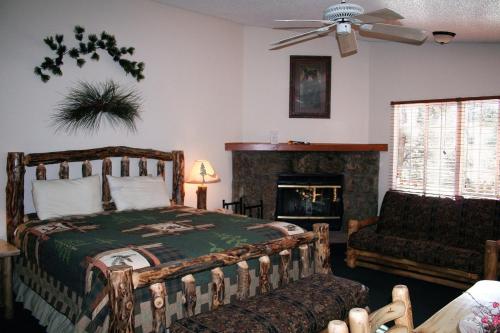 een slaapkamer met een bed en een open haard bij Timber Creek Chalets- 11 chalet in Estes Park