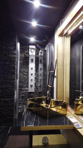 a bathroom with a gold sink on a table at #BBSH in Goussainville