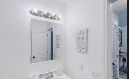 a bathroom with a sink and a mirror at Peace On The Beach House in Panama City Beach