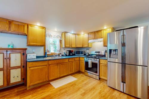 a kitchen with wooden cabinets and stainless steel appliances at Tranquil Seclusion in Augusta