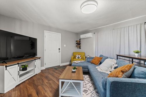 a living room with a blue couch and a tv at Tranquil Retreat: Cozy 2Bed, 1Bath Oasis in Fallon in Fallon