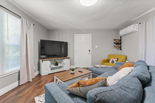 a living room with two blue couches and a tv at Tranquil Retreat: Cozy 2Bed, 1Bath Oasis in Fallon in Fallon