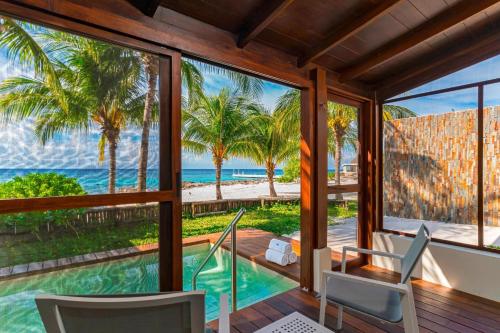 a house with a swimming pool and a view of the ocean at The Westin Cozumel in Cozumel