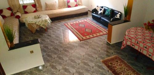 un soggiorno con divano e tavolo di Duplex Malika a El Jadida