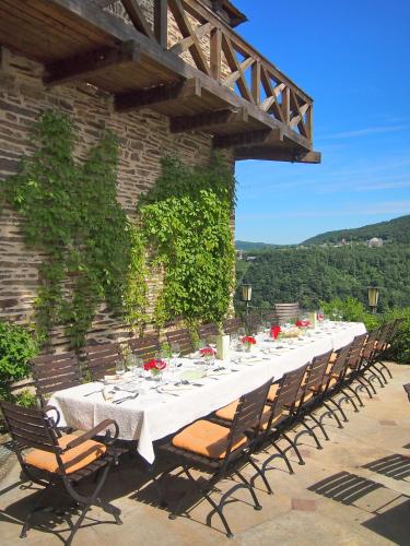 a long white table with chairs and flowers on it at Berghotel Wintersberg in Bad Ems