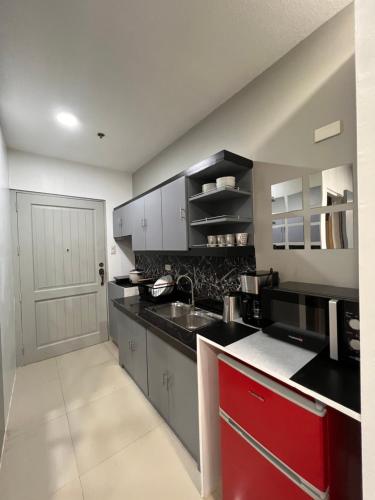 a kitchen with a sink and a red cabinet at *Top Choice Awardee A 2023 in Iloilo City