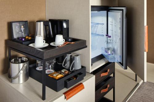 a room with a kitchen with a counter with a refrigerator at London Marriott Hotel Regents Park in London