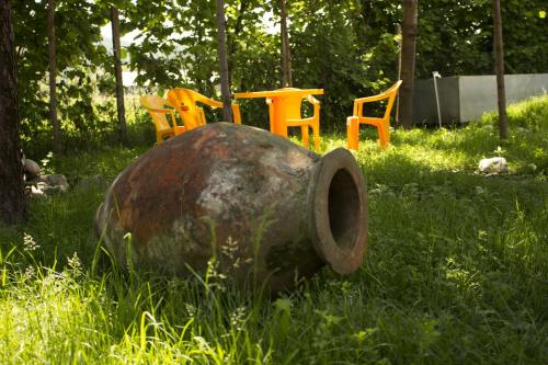 a group of chairs sitting in the grass at Nona Guest House in Shilda