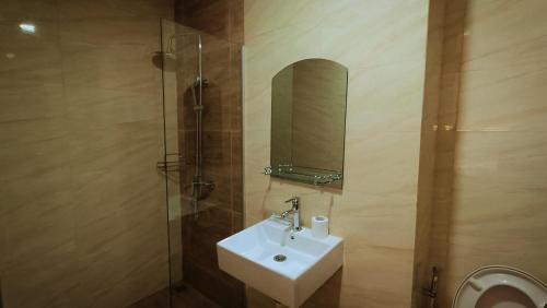 a bathroom with a sink and a mirror at SLEPTOPIA Premium Unit with Twin Queen Bed in Nagoya