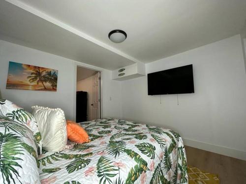 a bedroom with a bed and a flat screen tv at Sleeps 3, Casa Tropical in Miami in Miami