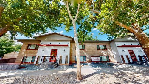a building with a tree in front of it at Moab Flats #1 in Moab
